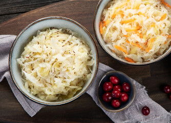 Sauerkraut on wooden background.
