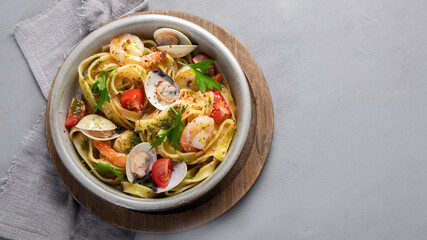 Pasta with seafood on gray background.