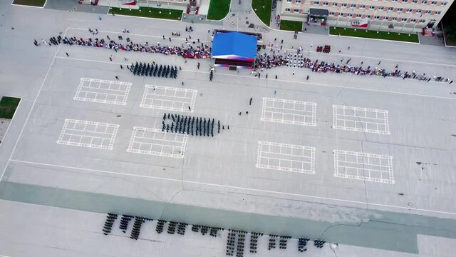 A line of soldiers marching on the parade ground. Military parade. March of officers. Video shooting from a copter of a military holiday