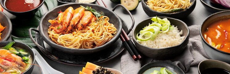 Asian dishes variety on gray background.