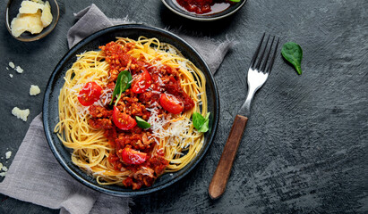 Spaghetti Bolognese on gray background.