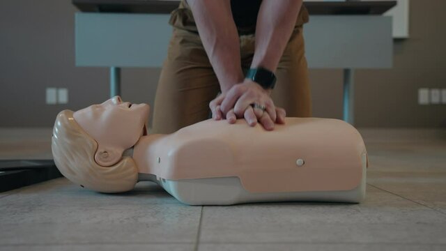 Health Worker Demonstrating CPR Of Mannequin. - close up