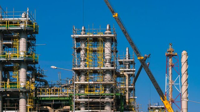 time lapse of worker and crane lift pipe equipment for maintenance and construction of oil, gas, chemical refinery industry for petrochemical business for energy development