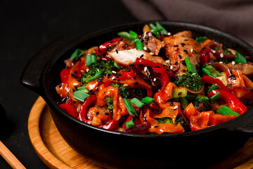 Asian cuisine, teriyaki meat with vegetables, in a cast-iron frying pan, close-up, no people,