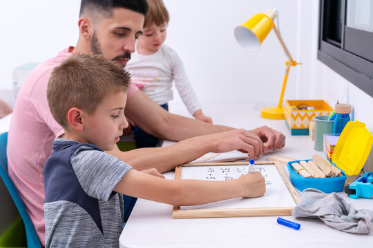 Father helping his son with homework
- Powered by Adobe
