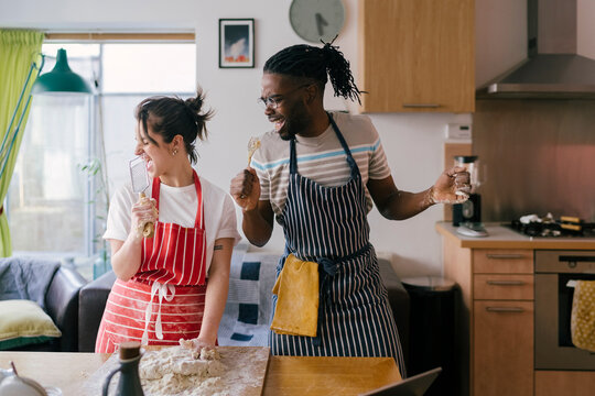 Young couple Singing while cooking