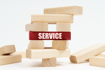 On the white surface there is a ruined tower made of planks, on a red plaque there is an inscription - SERVICE