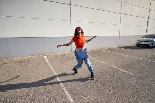 Woman riding roller skates on parking