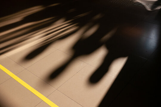Shadows of people on tiled floor
