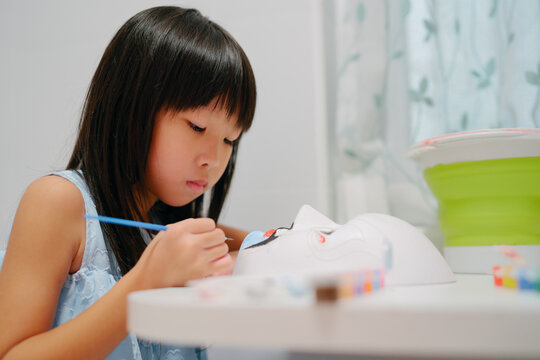kid painting Peking opera mask