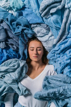 Woman with Blue Used Clothes for Recycling