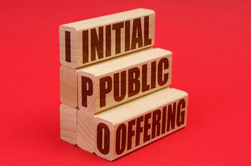 On a red background, wooden blocks with the inscription - Initial public offering