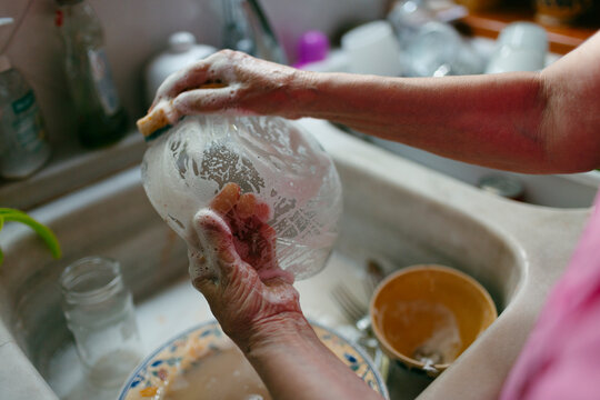 Woman's hands doing dishes