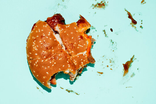 nibbled burger on a blue background