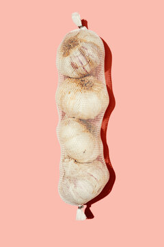 heads of garlic in a mesh bag