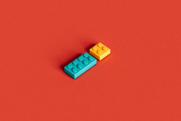 Colorful building blocks isolated on a red background