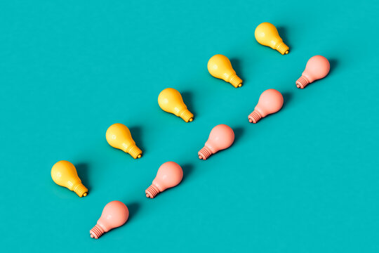 yellow and pastel pink light bulbs on blue background.