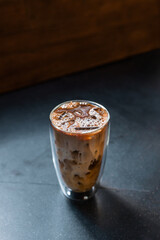 iced coffee with milk  served on the black table at a cafe​