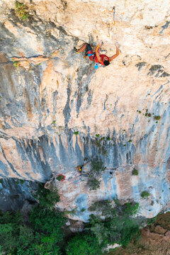 Climber rock climbing in cave