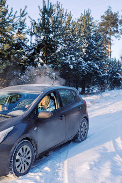 Woman driving through forest road