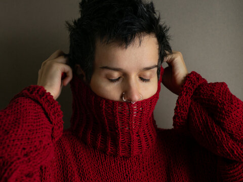 Portrait of a young woman in a red sweater