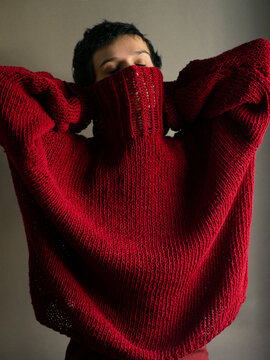 Portrait of a young woman in a red sweater