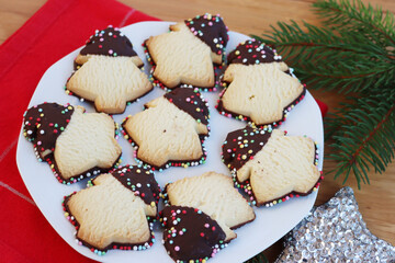 Christmas cookies made with shortcrust pastry and glazed with chocolate  and sprinkles in shape of...