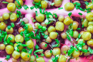 Salad with beets, potatoes, green peas, mayonnaise and green onions. Salad under a fur coat.