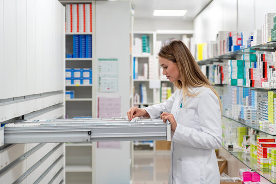 Pharmacist searching medicine in drawer