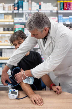 Practitioner measuring blood pressure of client