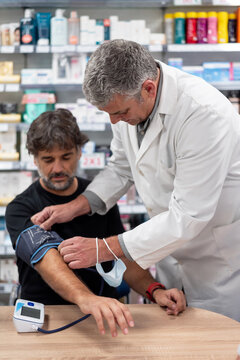 Practitioner measuring blood pressure of client
