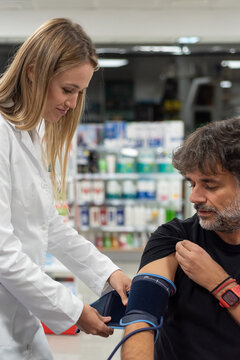 Practitioner measuring blood pressure of client