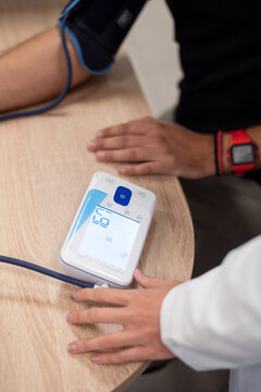 Practitioner measuring blood pressure of client
