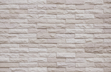 Fototapeta premium Cream and beige brick wall texture background. Brickwork and stonework flooring interior rock old pattern design. Background of old vintage brick wall backdrop