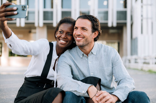 Happy multiethnic couple taking selfie
