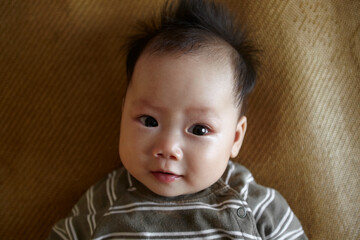 Big closeup of Asian baby's facial expressions

