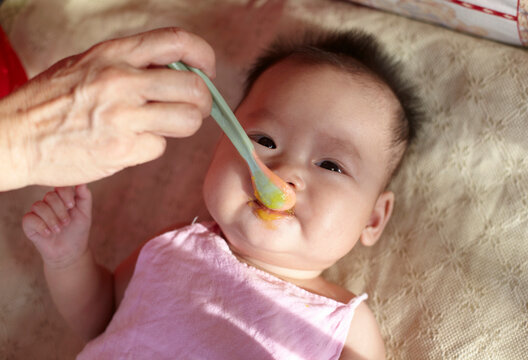 Close-up of Asian baby feeding