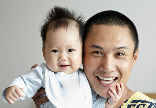 Interaction between Asian baby and dad