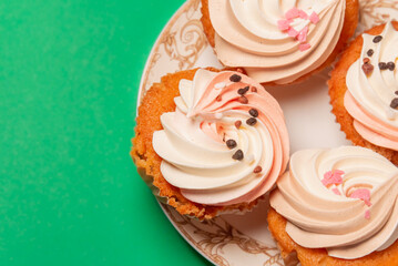Cupcake (cup cake) on a green background, table, baking fairy cake. Dessert.