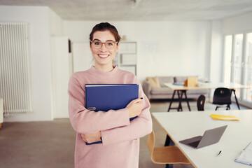 Happy successful young job applicant clutching a CV