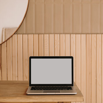 Blank screen laptop on wooden table. Home office desk table workspace. Copy space mockup blog, website template. Blogger, outsourcing work concept