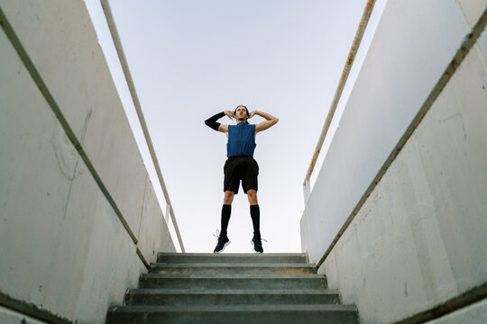 Sportsman stretching on stage