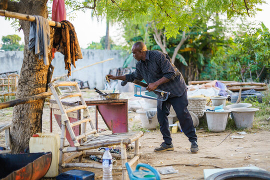 Man with tool working with wood