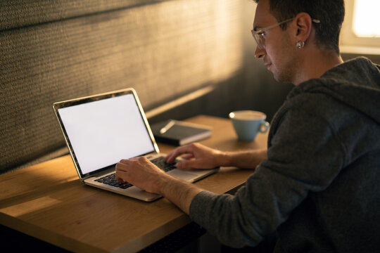 Young Man Typing On A Laptop