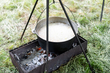 Porridge on the fire. Picnic and food in nature. Lifestyle.