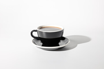 Close up of beverage in black cup with sauce