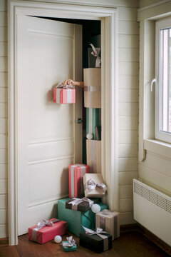 A mountain of wrapped New Year's gifts near the door