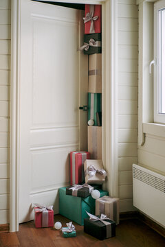A mountain of wrapped New Year's gifts near the door