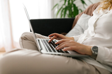 Anonymous woman typing on the computer indoors
