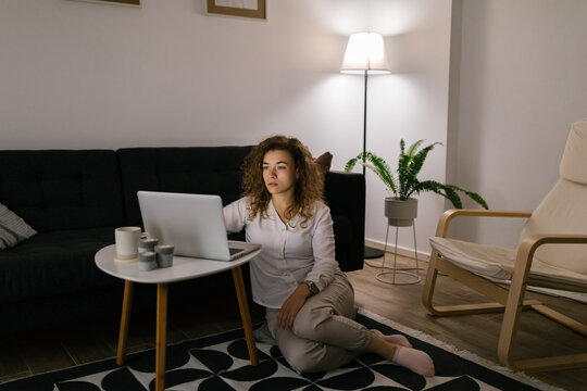 Young woman using computer in late hours at home